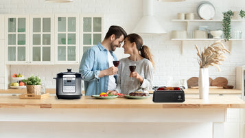 couple-making-a-toast-in-the-middle-of-their-kitchen-with-condura-rice-cooker-and-griller-concepstore-blog